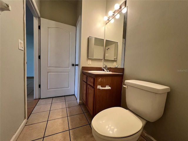 bathroom with vanity, toilet, and tile patterned flooring