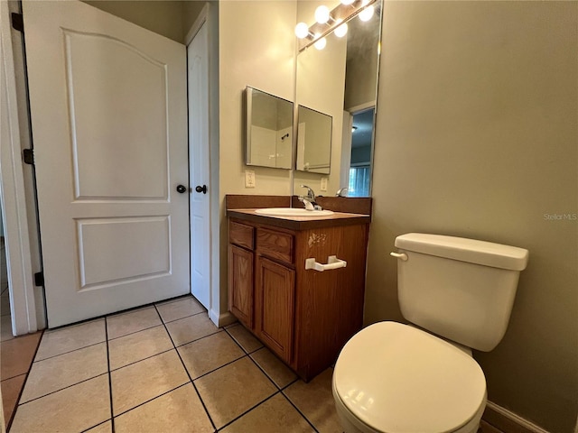 bathroom featuring tile patterned flooring, vanity, and toilet