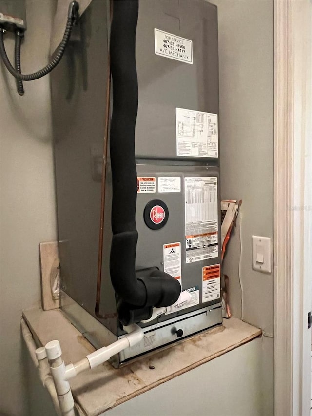 utility room featuring heating unit