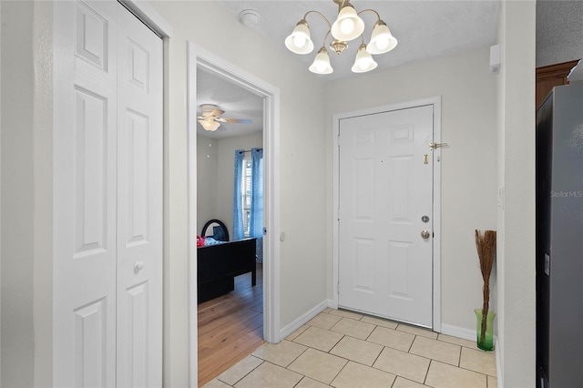 foyer entrance featuring ceiling fan and light tile patterned floors