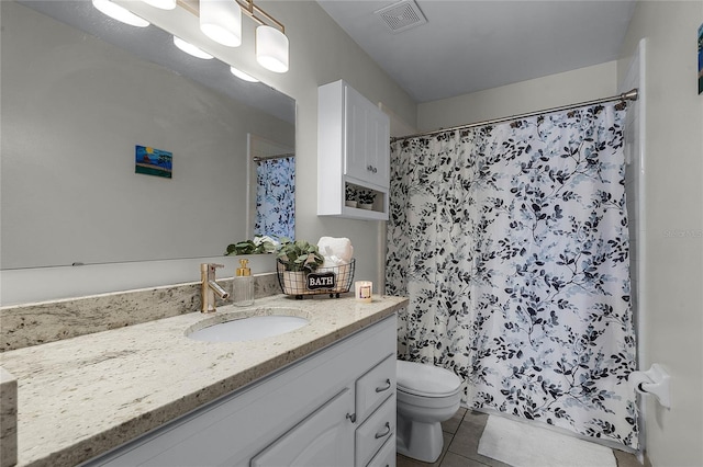 bathroom with a shower with curtain, vanity, toilet, and tile patterned flooring