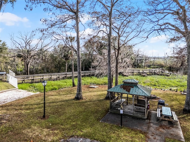 surrounding community with a yard and a gazebo