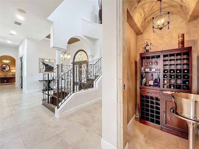 wine cellar with decorative columns and a notable chandelier