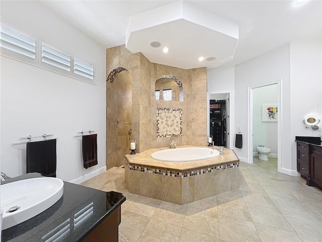 bathroom featuring tile patterned flooring, sink, tiled bath, and toilet