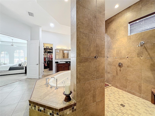 bathroom featuring vanity, tile patterned floors, ceiling fan, and plus walk in shower