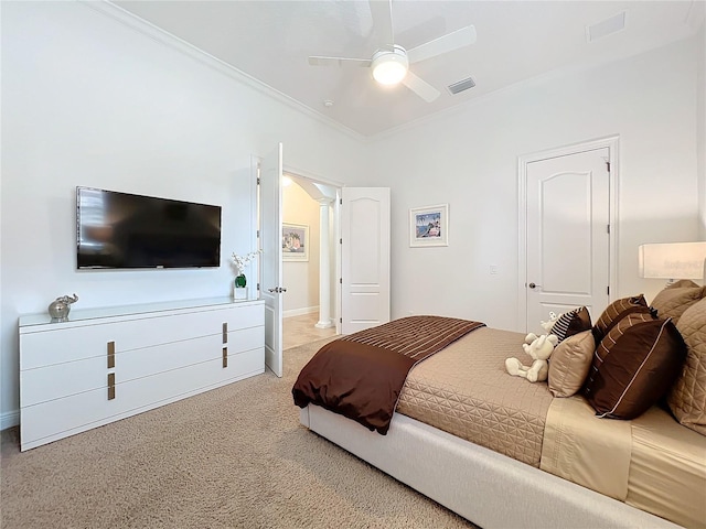 carpeted bedroom with ceiling fan, ornamental molding, and decorative columns