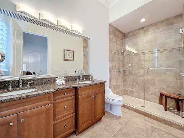 bathroom with vanity, a shower with shower door, and toilet