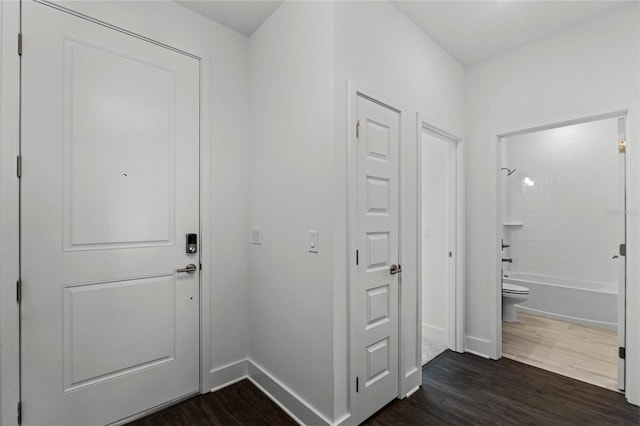 interior space featuring dark wood-style floors and baseboards