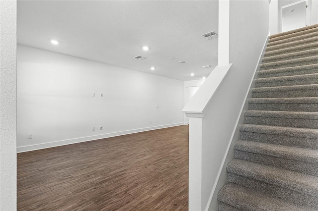 stairs with recessed lighting, wood finished floors, visible vents, and baseboards