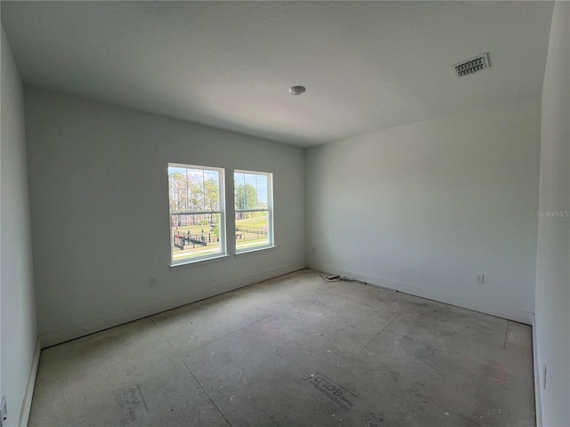 spare room featuring visible vents and baseboards