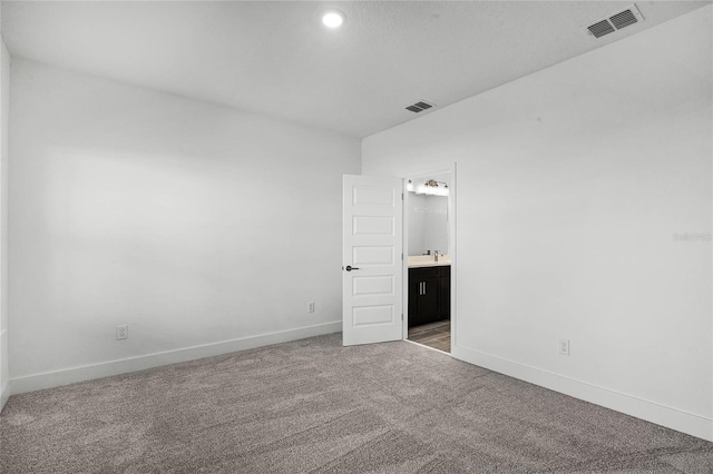 unfurnished bedroom featuring carpet flooring, baseboards, and visible vents