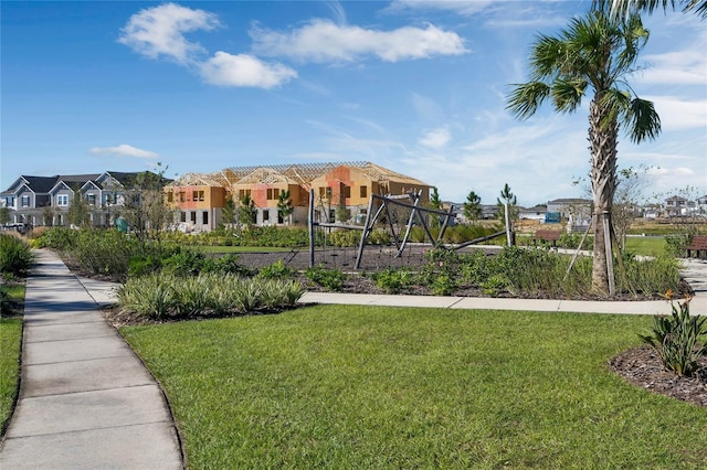 view of home's community featuring playground community, a residential view, and a lawn