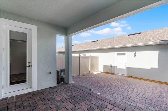 view of patio / terrace featuring central AC and fence