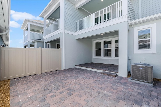 view of patio featuring cooling unit and fence