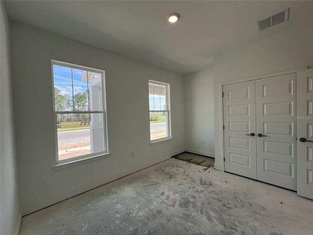 unfurnished bedroom featuring visible vents, baseboards, and a closet