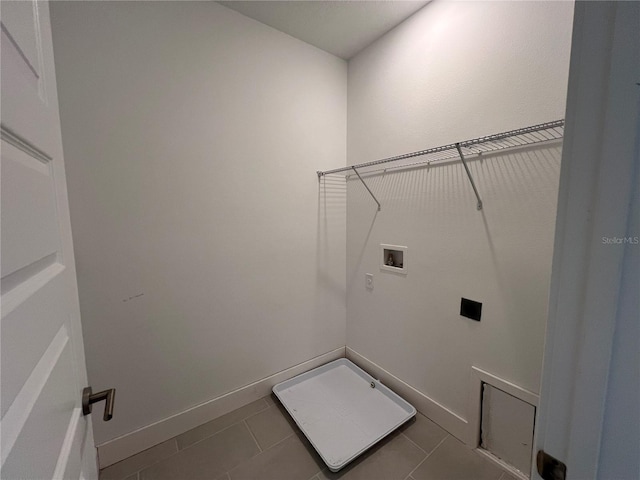 laundry room featuring baseboards, laundry area, electric dryer hookup, washer hookup, and tile patterned flooring