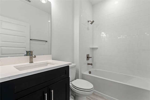 full bathroom with toilet, vanity, and shower / tub combination