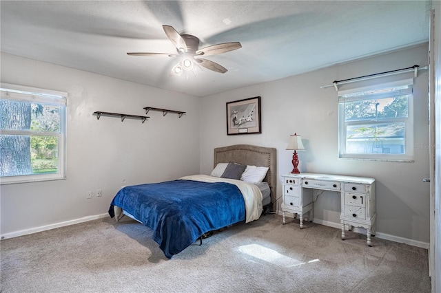 bedroom with light carpet and ceiling fan