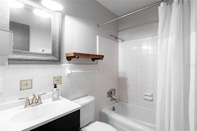 full bathroom with vanity, toilet, shower / bath combo with shower curtain, and tile walls