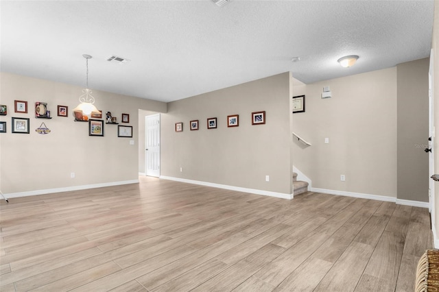 interior space featuring light hardwood / wood-style floors and a textured ceiling