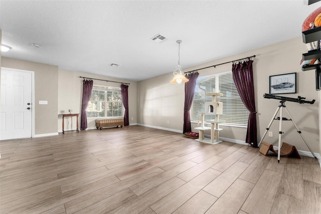 interior space featuring a textured ceiling and light wood-type flooring