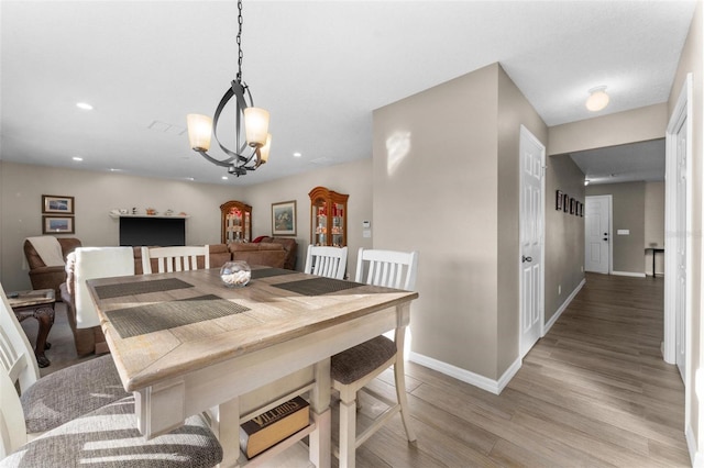 dining area featuring a chandelier and light hardwood / wood-style floors