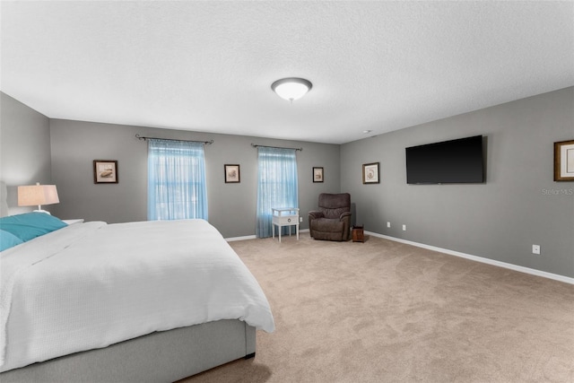 bedroom featuring light carpet and a textured ceiling