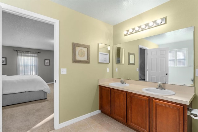 bathroom featuring vanity, tile patterned floors, and a textured ceiling