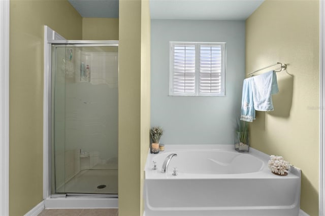 bathroom with tile patterned floors and independent shower and bath