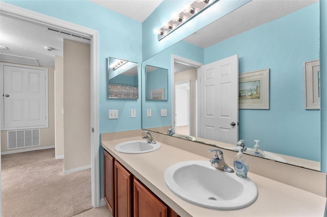 bathroom featuring vanity and a textured ceiling