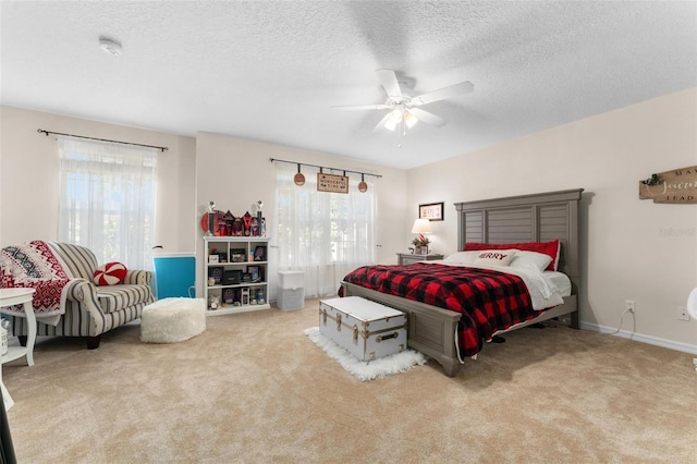 bedroom featuring light carpet, multiple windows, and ceiling fan