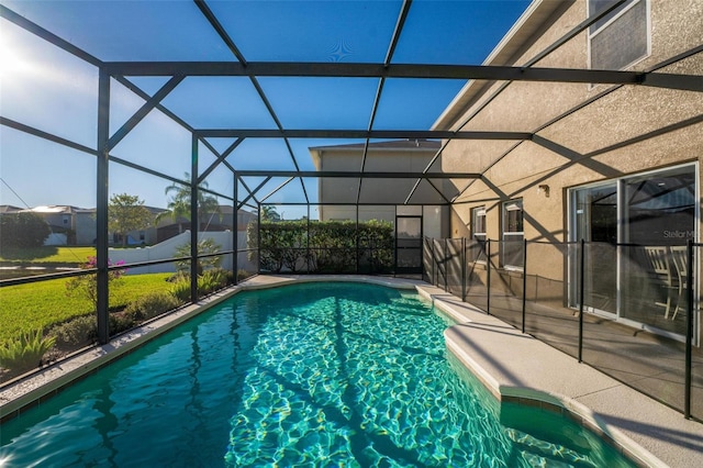 view of swimming pool featuring a lanai