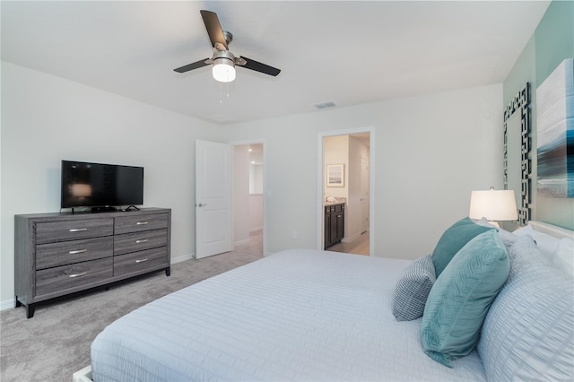 carpeted bedroom with connected bathroom and ceiling fan