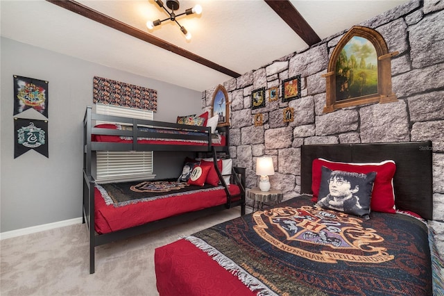 carpeted bedroom featuring beam ceiling and a stone fireplace