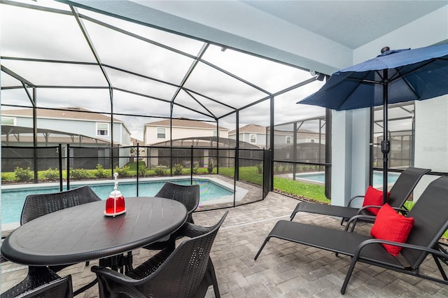 view of patio / terrace featuring a fenced in pool and glass enclosure