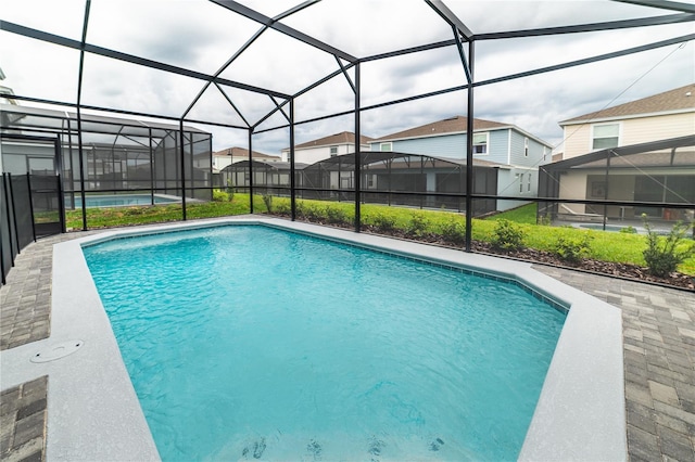 view of swimming pool with a lanai and a patio area