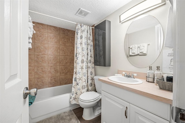 full bathroom with hardwood / wood-style flooring, vanity, toilet, shower / bathtub combination with curtain, and a textured ceiling