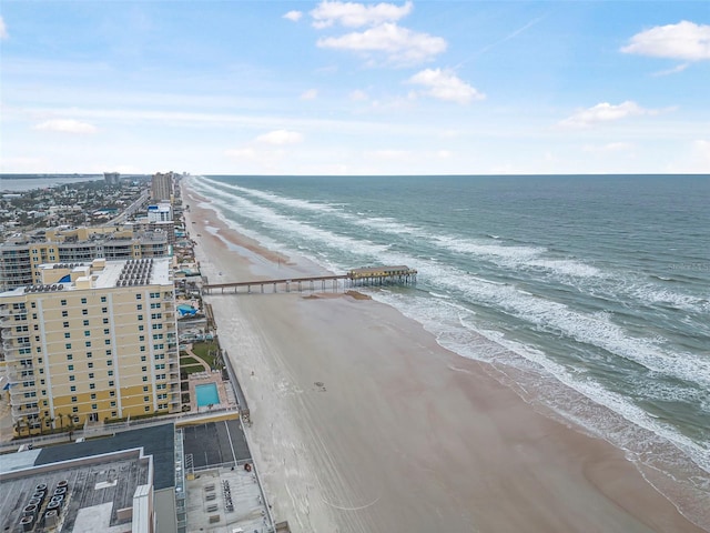 bird's eye view featuring a water view and a beach view