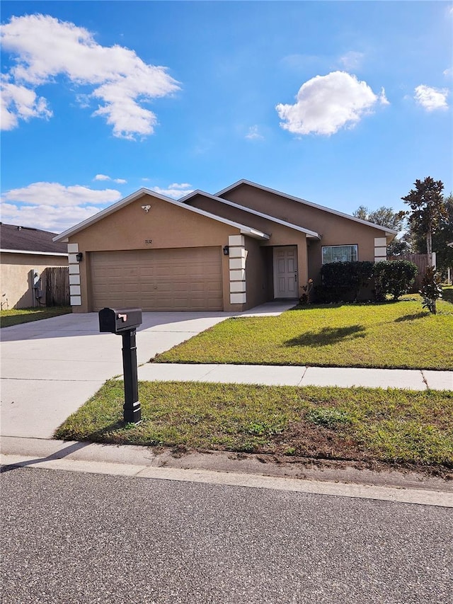 ranch-style house with a garage and a front yard