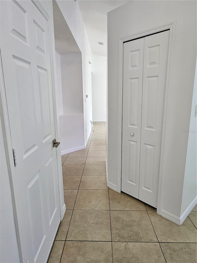 hallway featuring light tile patterned floors