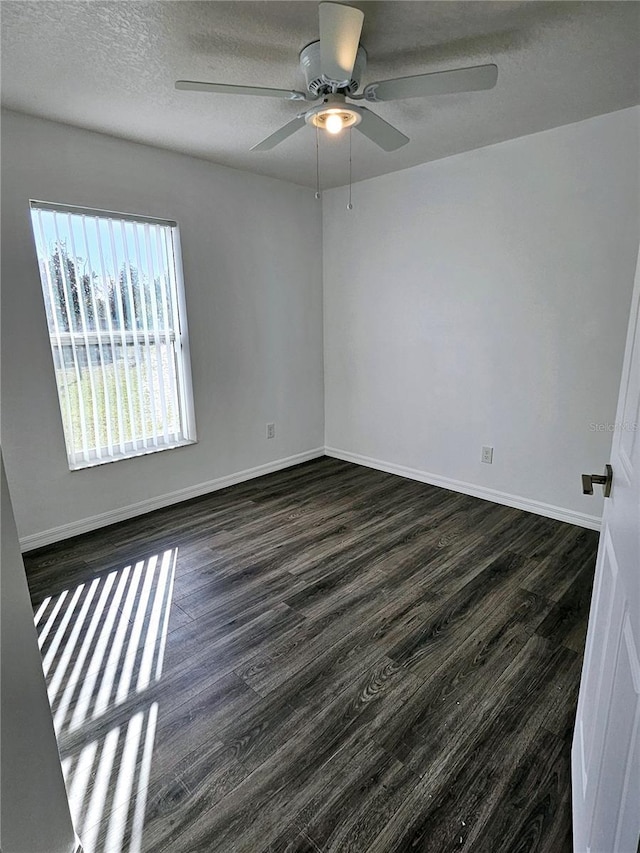 unfurnished room with ceiling fan, dark hardwood / wood-style floors, and a textured ceiling