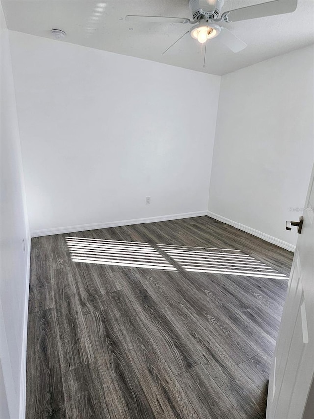 unfurnished room featuring dark hardwood / wood-style flooring and ceiling fan