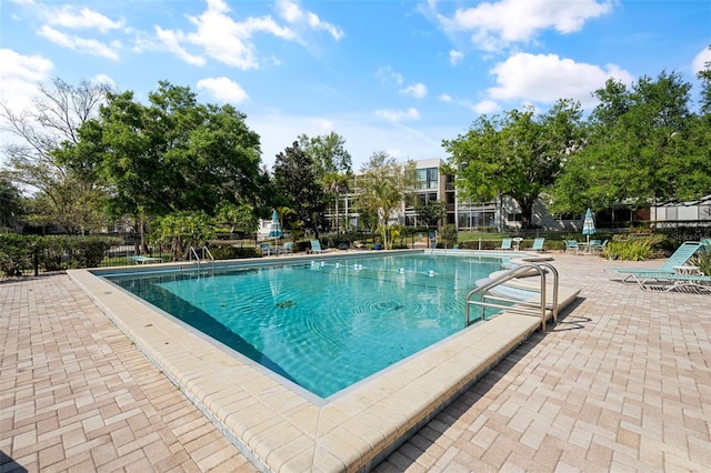 view of swimming pool with a patio