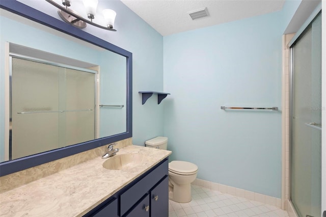 bathroom featuring tile patterned flooring, vanity, a textured ceiling, a shower with shower door, and toilet