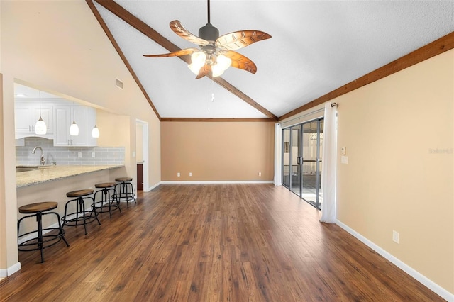 living room with sink, high vaulted ceiling, dark hardwood / wood-style floors, and ceiling fan