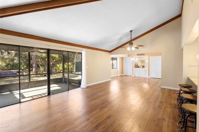 unfurnished living room with hardwood / wood-style floors, plenty of natural light, high vaulted ceiling, and ceiling fan