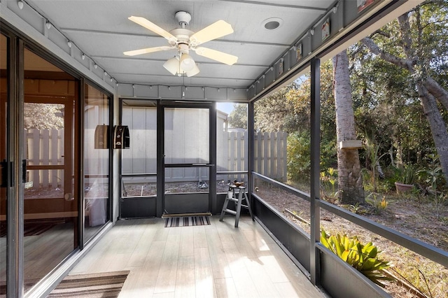 unfurnished sunroom with ceiling fan