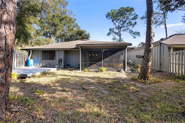 back of property featuring a wooden deck and a sunroom