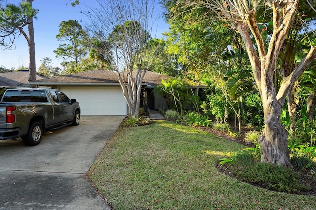 view of front of home with a garage and a front lawn