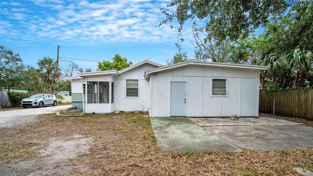 rear view of property featuring a sunroom